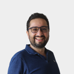 The general public and the educational community are introduced to Professor Javier Orlando Aguirre Román from the School of Philosophy. The photo was taken in close-up, on a white background, with the professor positioned in the center.