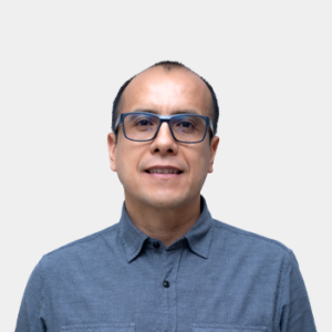 The photo was taken in the foreground, white background and the teacher Carlos Andres Cardenas is located in the centre.